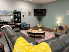 Lounge area with a couch and TV in the Christiansburg Star Center