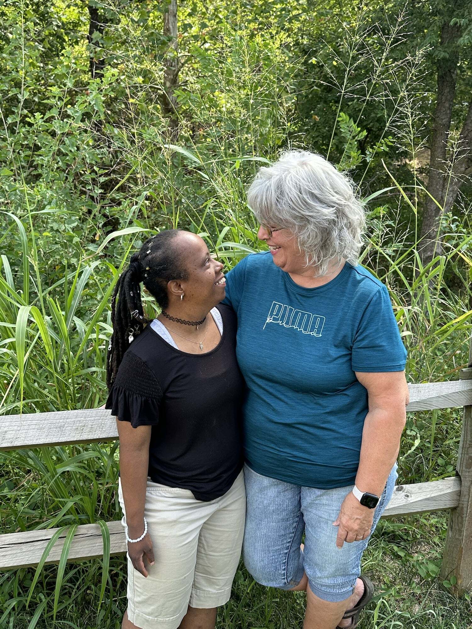 An individual and a provider side by side smiling at each other