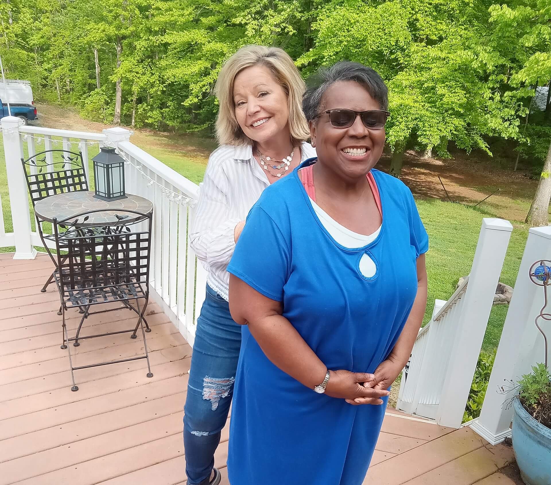 Two women standing on a porch