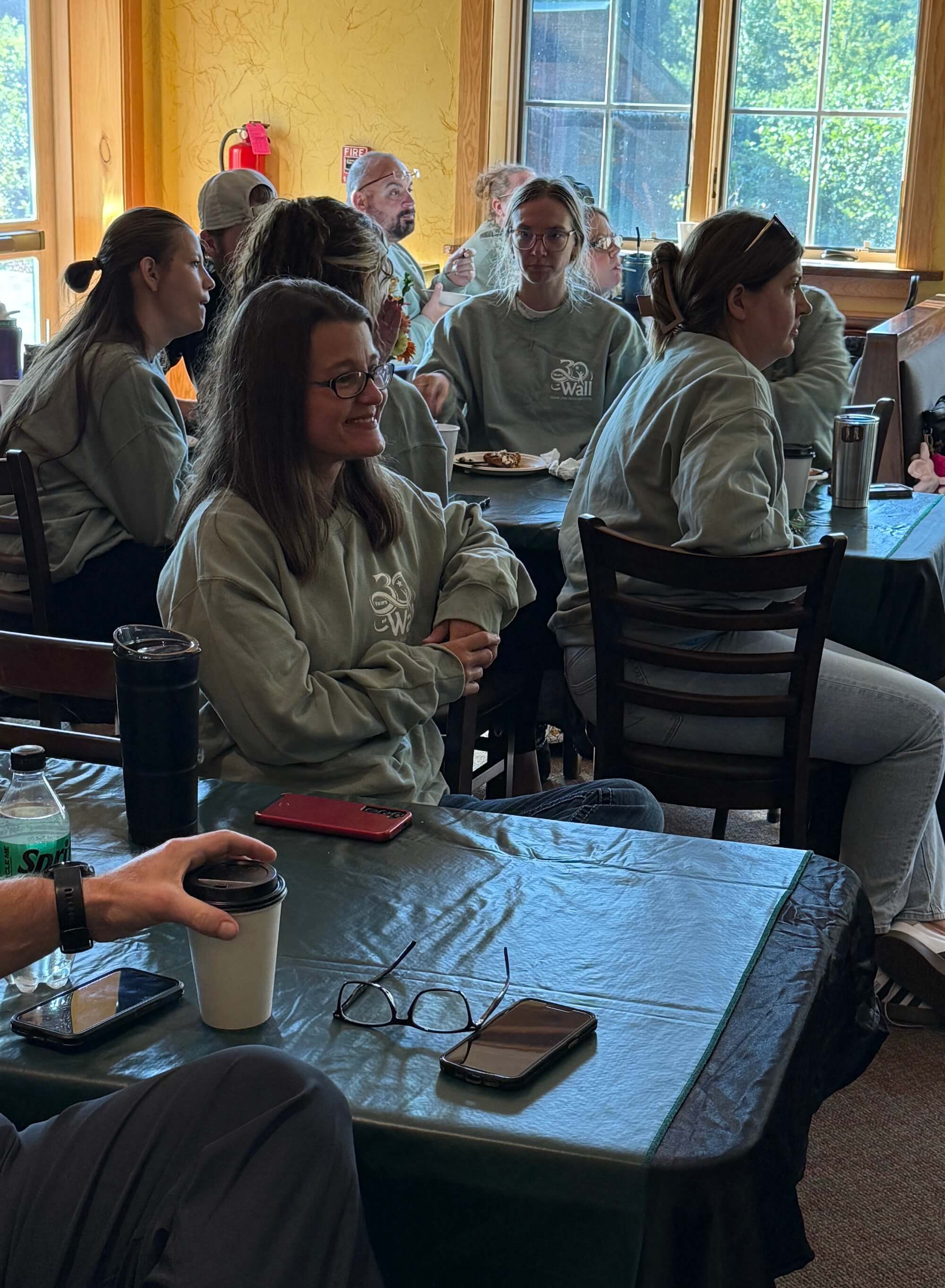 Wall therapeutic solutions staff gathered at tables during a team-building exercise at a conference